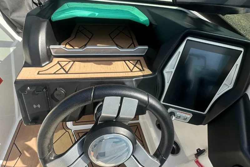 Slide: The Image of 2022 Tigé Z3 boat dashboard with steering wheel and touchscreen display. - 8