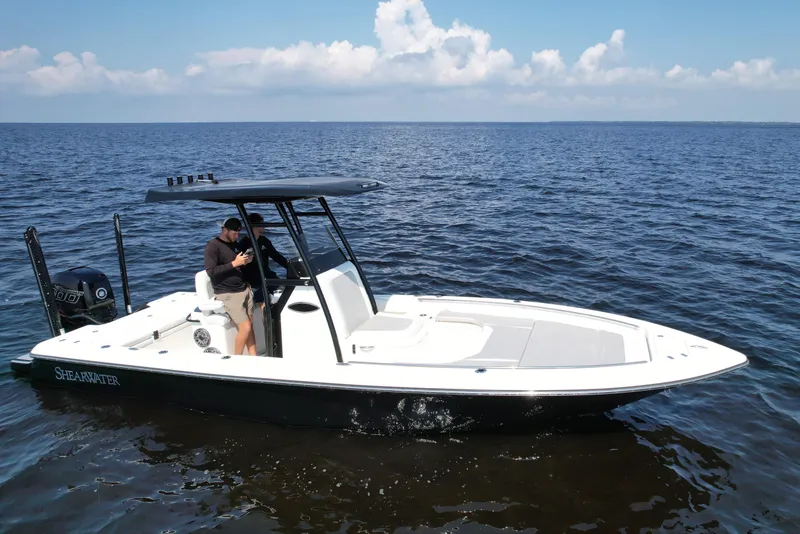 Slide: The Image of 2022 ShearWater 270 Carolina Flare boat on open water, clear sky background. - 1