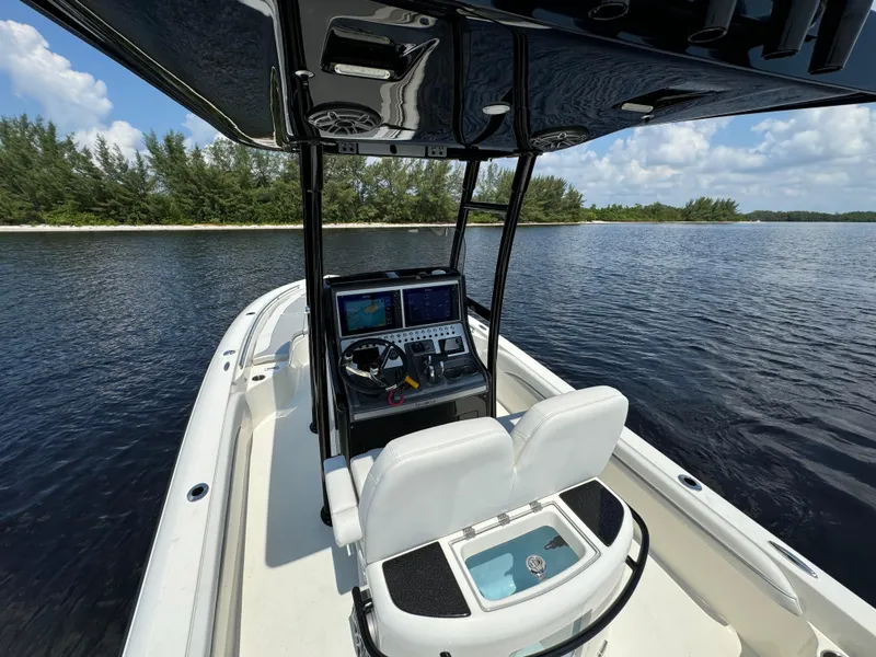 Slide: The Image of 2022 ShearWater 270 Carolina Flare boat interior with navigation console on calm water. - 13