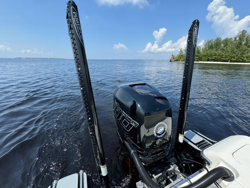 Slide: The Image of 2022 ShearWater 270 Carolina Flare boat with powerful outboard motor on calm water. - 16