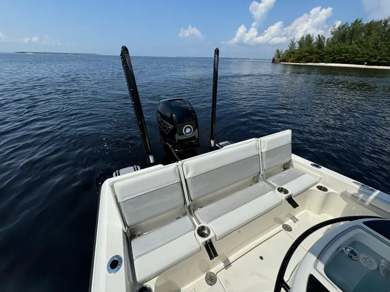 Slide: The Image of 2022 ShearWater 270 Carolina Flare boat on calm water, featuring spacious seating and powerful engine. - 18