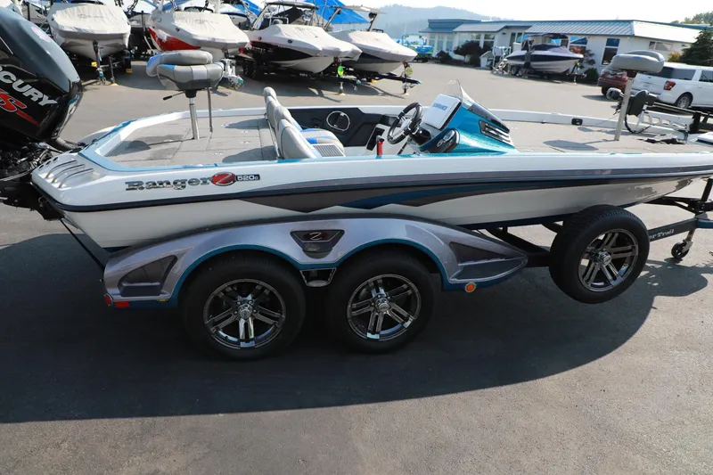 Slide: The Image of 2018 Ranger 521C boat with dual axles, parked outdoors. - 2