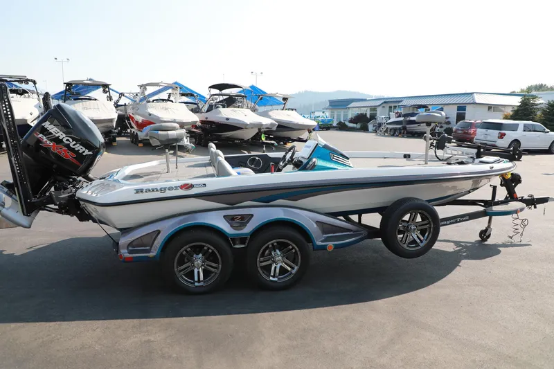 Slide: The Image of 2018 Ranger 521C boat with Mercury engine, parked in a marina lot. - 3
