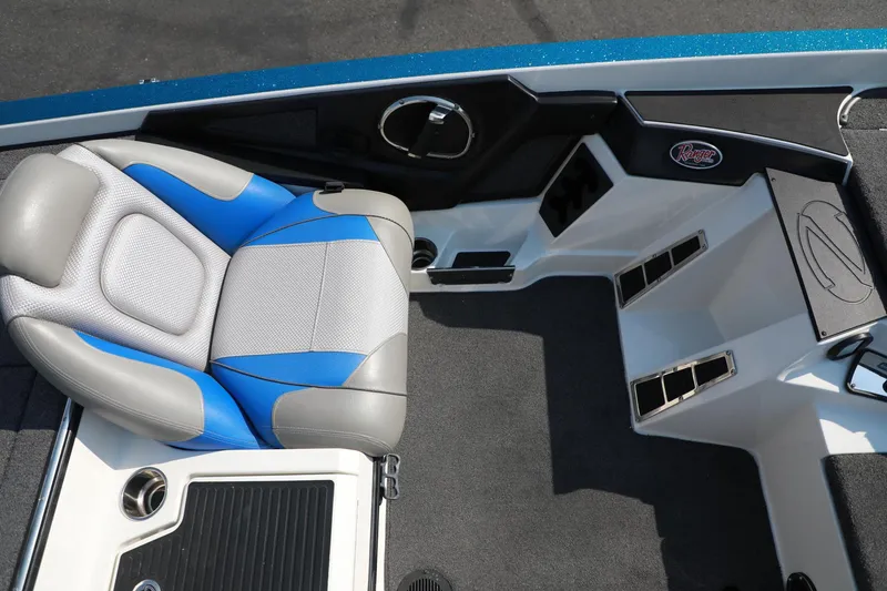 Slide: The Image of 2018 Ranger 521C boat interior with blue and gray seating and storage compartments. - 9