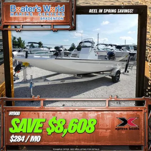 Slide: The Image of 2025 Xpress Boats H190B on trailer, displayed outdoors in a boat dealership. - 1