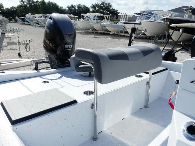 Slide: The Image of 2025 Xpress Boats H190B in a boatyard, featuring a spacious deck and seating. - 10