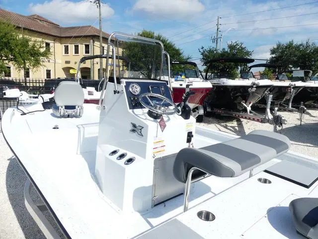 Slide: The Image of 2025 Xpress Boats H190B, sleek white design, modern console, outdoor display. - 14