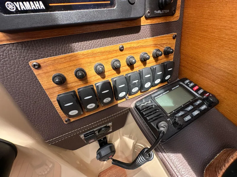 Slide: The Image of Control panel of 2019 Ranger Tugs R-23 boat with switches and radio equipment. - 29