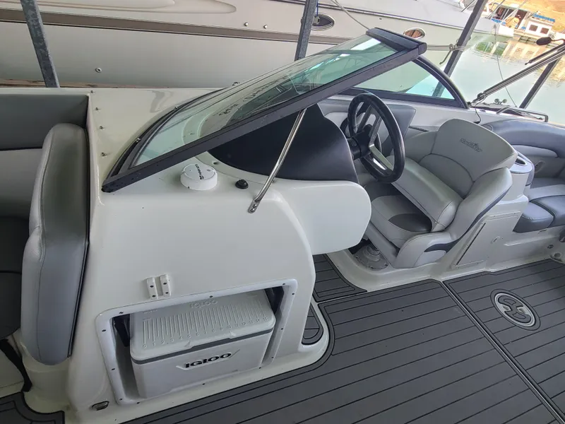 Slide: The Image of 2021 NauticStar 243 DC boat interior with steering wheel and seating. - 11