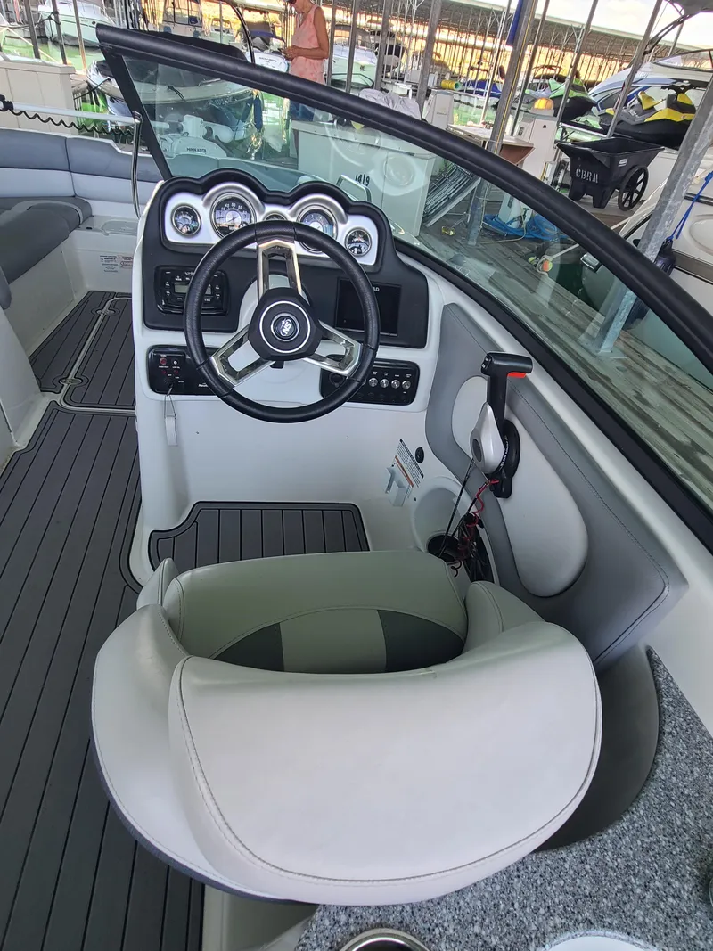Slide: The Image of 2021 NauticStar 243 DC boat interior with steering wheel and dashboard controls. - 13