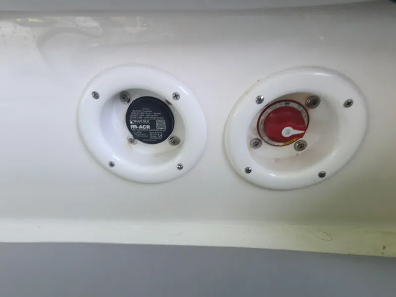 Slide: The Image of NauticStar 243 DC 2021 boat fuel and water inlets on white hull. - 16