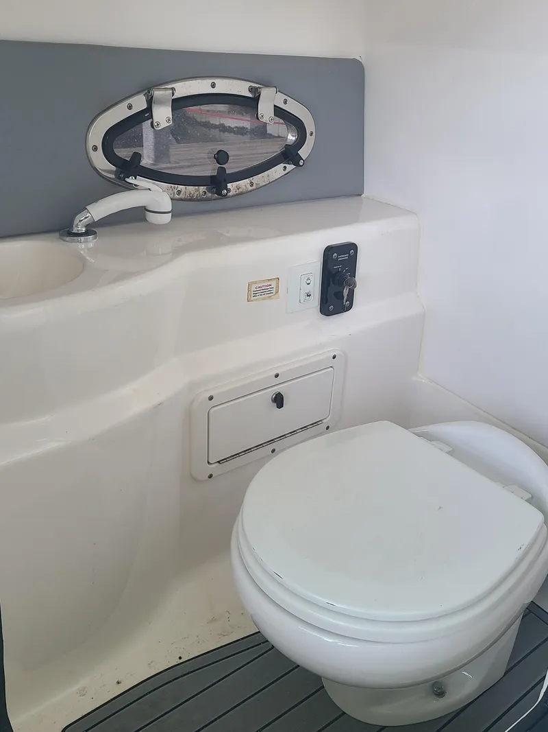 Slide: The Image of 2021 NauticStar 243 DC boat bathroom with sink and toilet. - 17