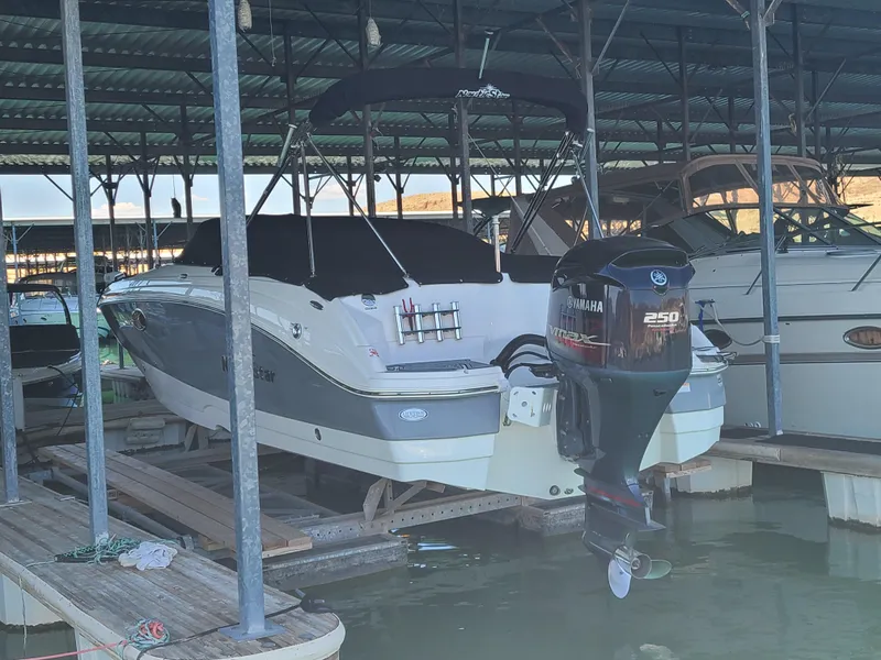 Slide: The Image of 2021 NauticStar 243 DC boat docked with Yamaha 250 outboard motor. - 5