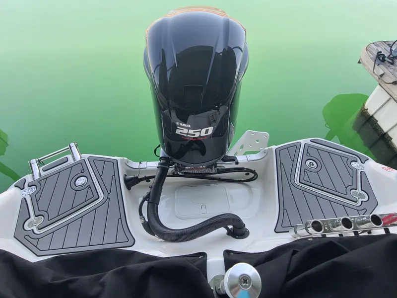 Slide: The Image of 2021 NauticStar 243 DC boat with Yamaha 250 engine on green water. - 7