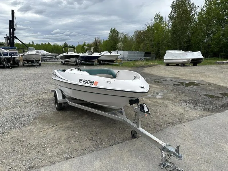 Slide: The Image of 1995 Four Winns Fling boat on trailer in outdoor storage area. - 2