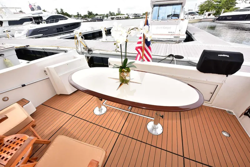 Slide: The Image of Luxurious 2004 Navigator Rival yacht deck with elegant table and chairs. - 12