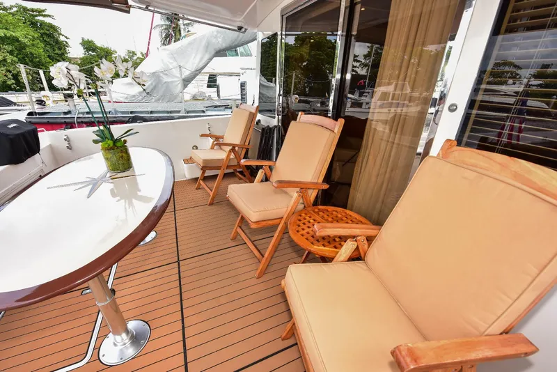 Slide: The Image of Luxurious 2004 Navigator Rival yacht deck with comfortable seating and elegant table setting. - 13