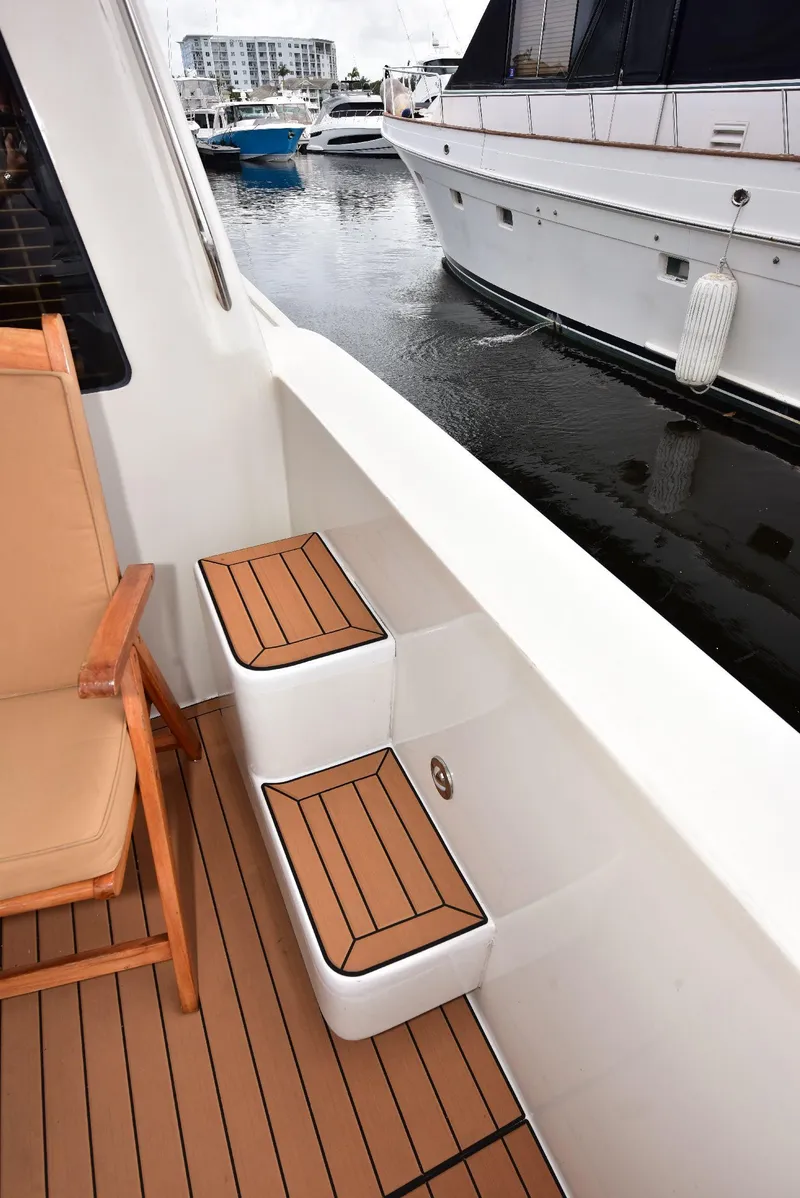 Slide: The Image of 2004 Navigator Rival yacht deck with wooden steps and marina view. - 14