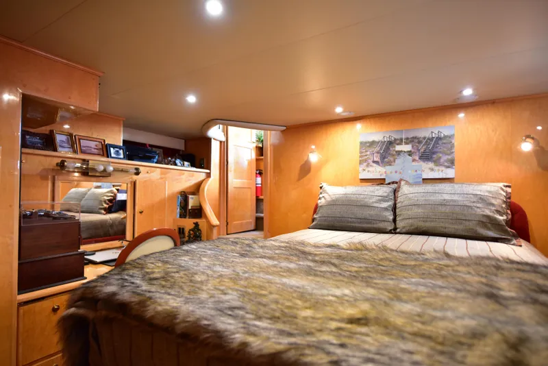 Slide: The Image of Luxurious 2004 Navigator Rival yacht bedroom with cozy lighting and elegant wood finishes. - 26