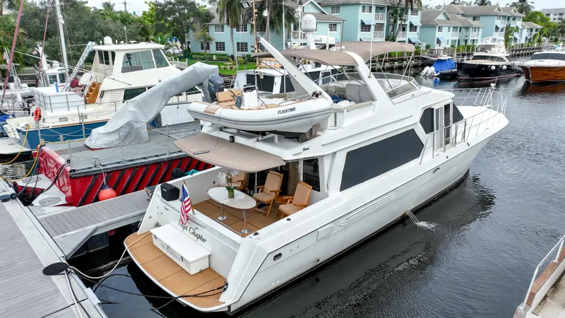 Slide: The Image of 2004 Navigator Rival yacht docked at marina, featuring spacious deck and modern design. - 3