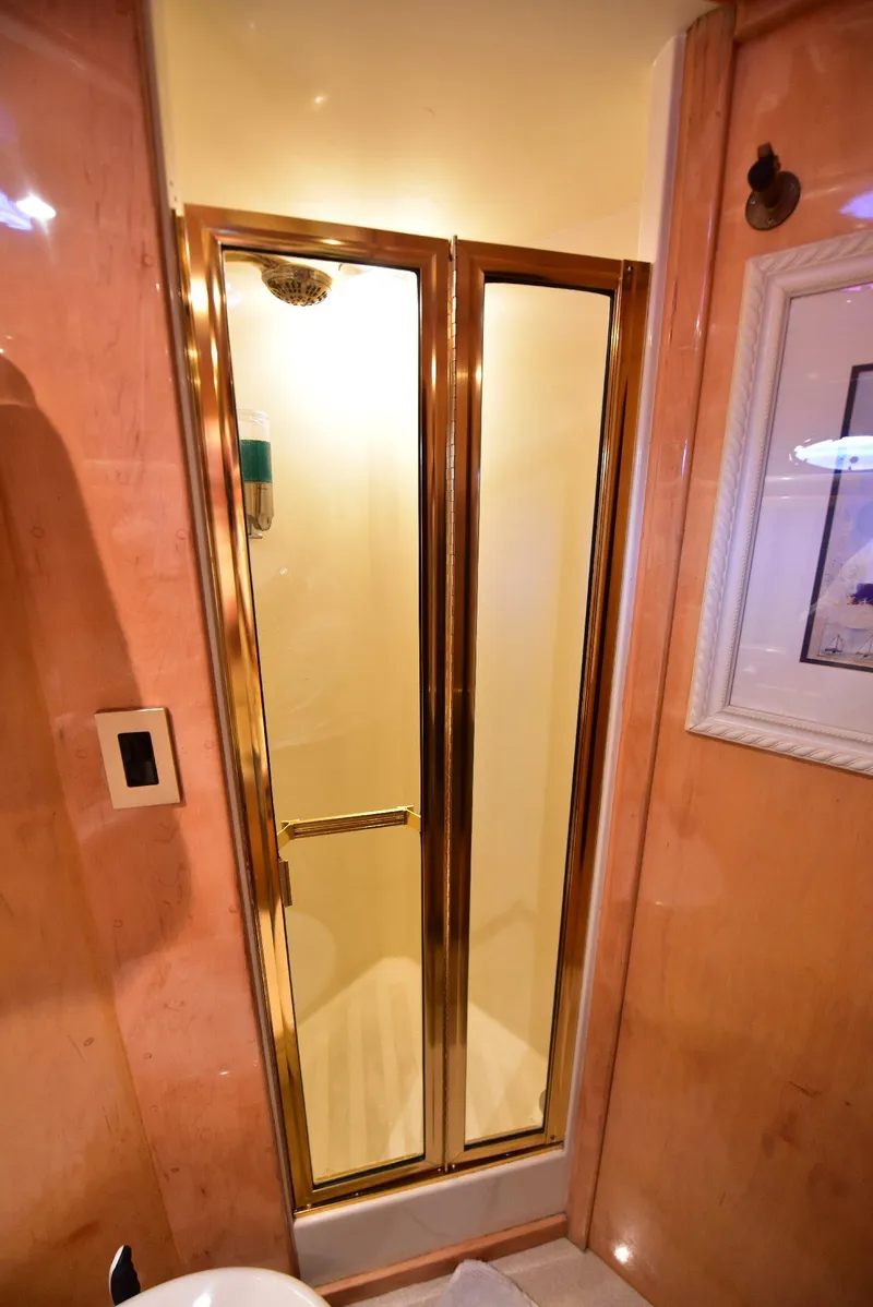 Slide: The Image of Luxurious 2004 Navigator Rival shower with gold-framed glass doors in elegant bathroom setting. - 32