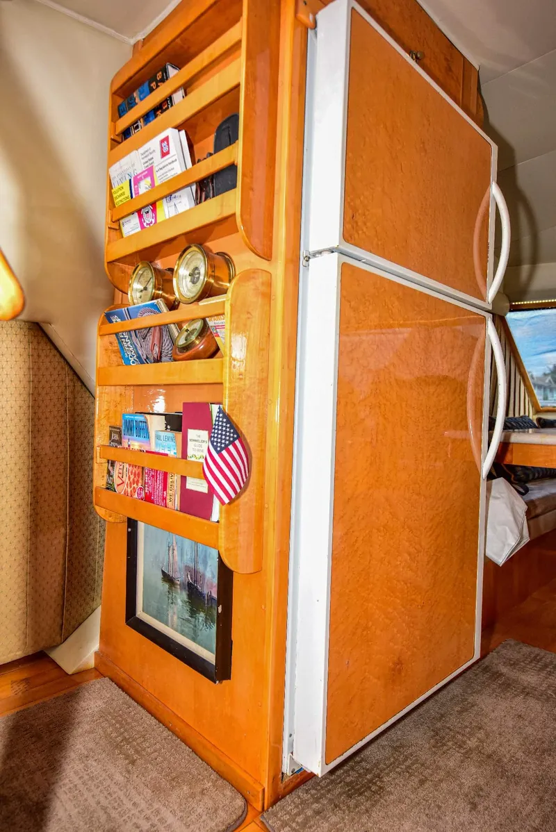 Slide: The Image of 2004 Navigator Rival RV interior with wooden storage shelves and refrigerator. - 34
