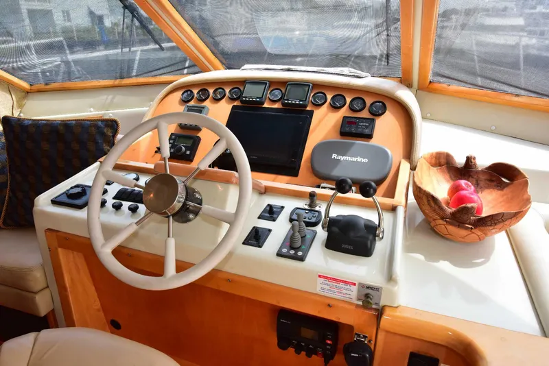 Slide: The Image of 2004 Navigator Rival yacht helm with steering wheel, navigation controls, and fruit basket. - 40