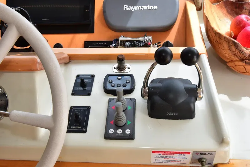 Slide: The Image of 2004 Navigator Rival boat control panel with steering wheel and navigation equipment. - 41