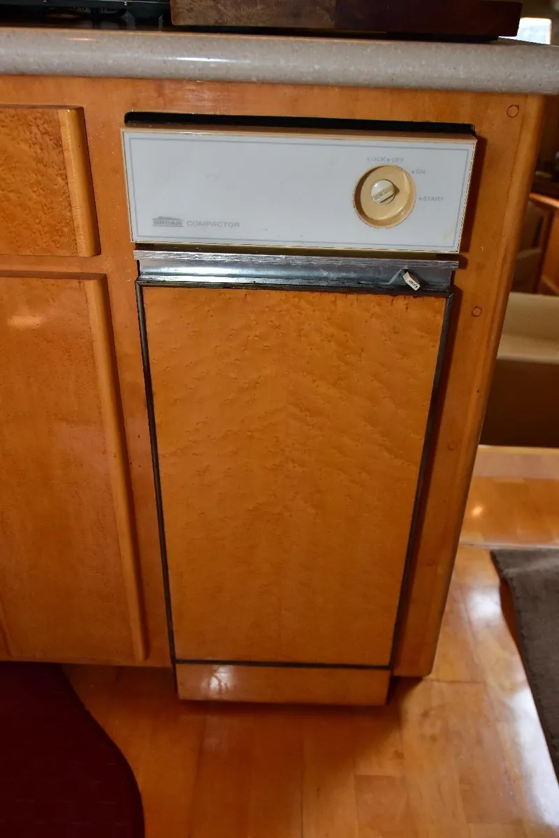 Slide: The Image of 2004 Navigator Rival dishwasher with wood paneling in a kitchen setting. - 43