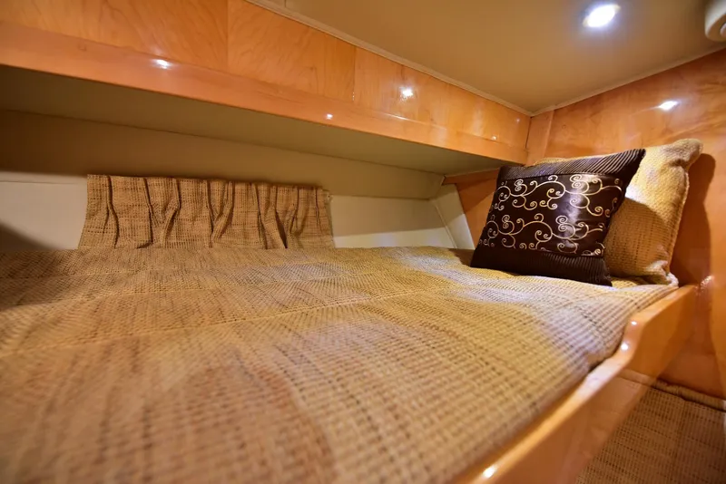 Slide: The Image of Cozy cabin interior of 2004 Navigator Rival yacht with elegant bedding and ambient lighting. - 47