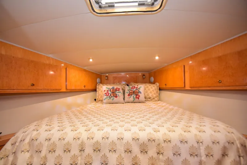 Slide: The Image of Cozy bedroom in 2004 Navigator Rival yacht with wood cabinets and floral bedding. - 49