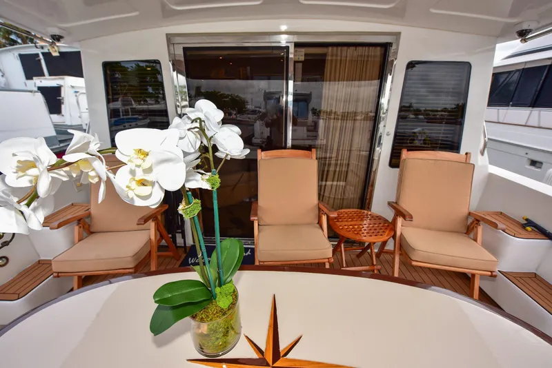 Slide: The Image of Luxurious 2004 Navigator Rival yacht deck with elegant seating and orchid centerpiece. - 7