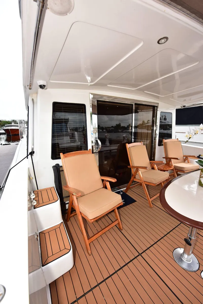 Slide: The Image of 2004 Navigator Rival yacht deck with seating and table. - 9