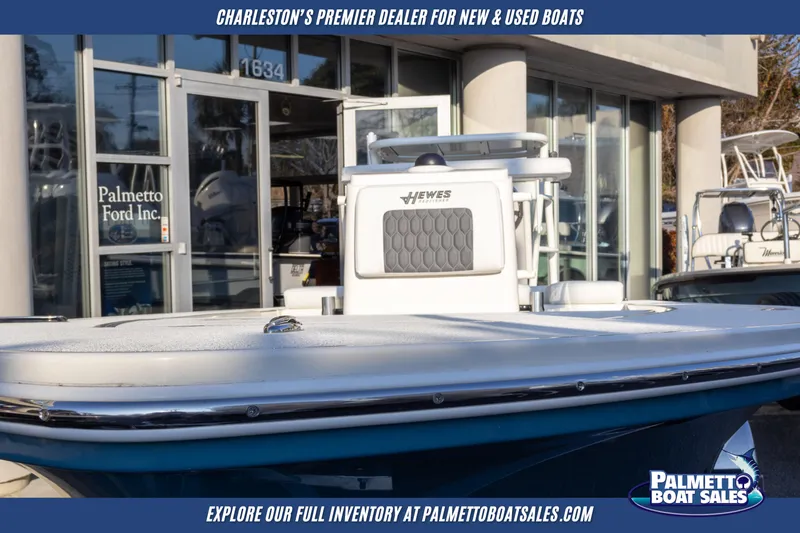 Slide: The Image of 2025 Hewes Redfisher 16 boat displayed at Palmetto Boat Sales dealership. - 2