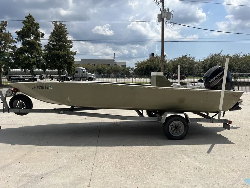 Slide: The Image of Nova 20 boat on trailer, 2000 model, parked outdoors under cloudy sky. - 10