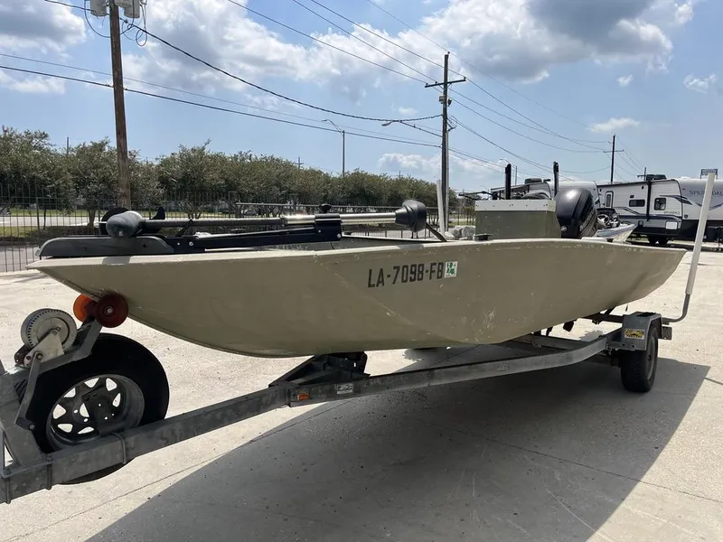Slide: The Image of Nova 20 boat on trailer, 2000 model, parked outdoors under cloudy sky. - 11