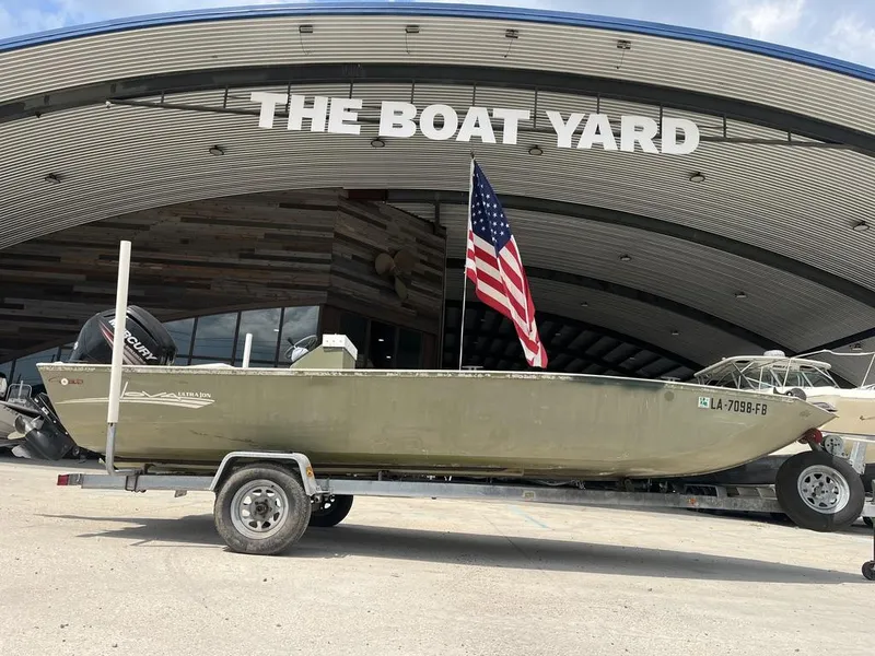 Slide: The Image of Nova 20 boat from 2000 on trailer at The Boat Yard, American flag displayed. - 3