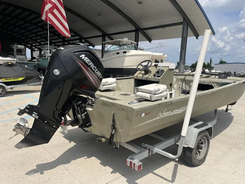 Slide: The Image of Nova 20 boat from 2000 with Mercury outboard motor on trailer, under a canopy. - 4