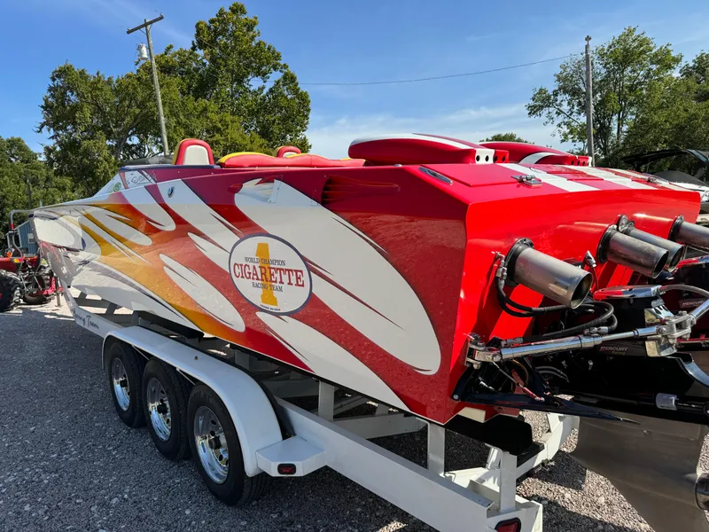 Slide: The Image of 2002 Cigarette 36 Gladiator speedboat with vibrant red and white design on a trailer. - 10