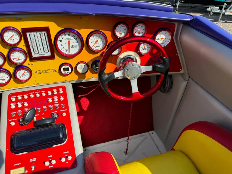 Slide: The Image of 2002 Cigarette 36 Gladiator dashboard with vibrant gauges and controls. - 16