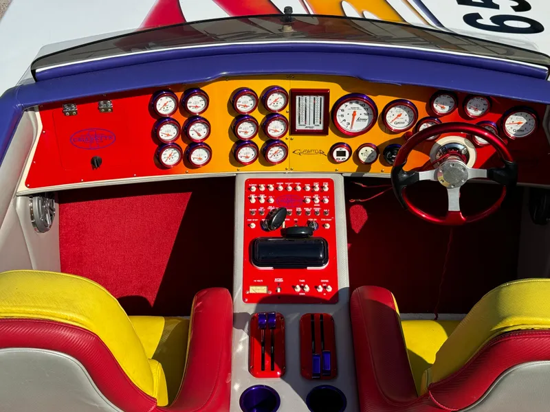 Slide: The Image of Vibrant dashboard of a 2002 Cigarette 36 Gladiator boat with colorful gauges and controls. - 21