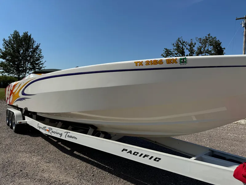 Slide: The Image of 2002 Cigarette 36 Gladiator boat on trailer, side view, sunny day. - 3