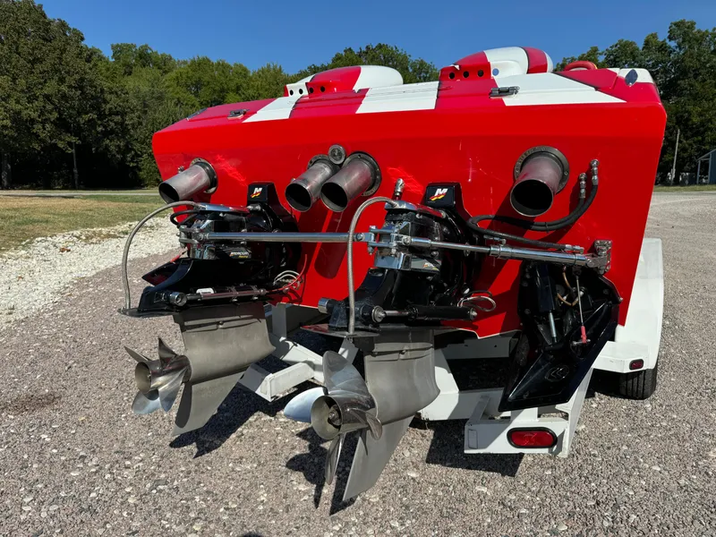 Slide: The Image of 2002 Cigarette 36 Gladiator boat with triple outboard engines, red and white design. - 8