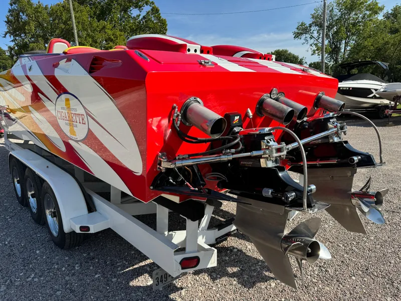 Slide: The Image of Red 2002 Cigarette 36 Gladiator speedboat on trailer, featuring dual propellers. - 9