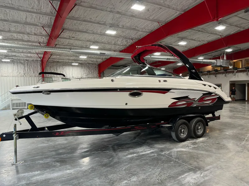 The Image of 2011 Chaparral 267 SSX boat on trailer in indoor storage facility. - 1