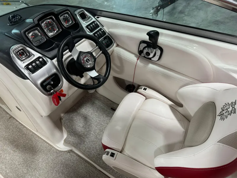 Slide: The Image of 2011 Chaparral 267 SSX boat cockpit with steering wheel and control panel. - 12
