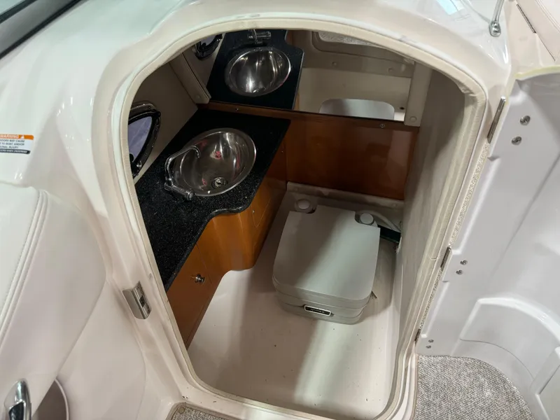 Slide: The Image of 2011 Chaparral 267 SSX boat interior with sink and portable toilet. - 13