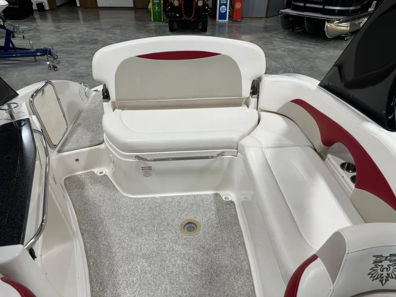 Slide: The Image of 2011 Chaparral 267 SSX boat interior with white and red seating. - 8