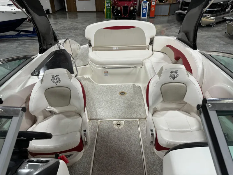 Slide: The Image of 2011 Chaparral 267 SSX boat interior with white and red seating, spacious layout. - 9