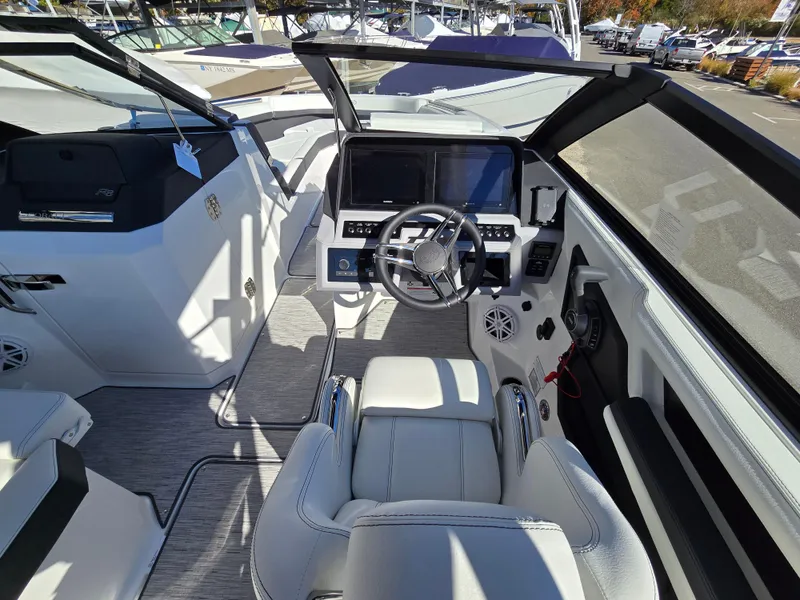 Slide: The Image of 2025 Cobalt R8 boat cockpit with modern steering and dual screens. - 9